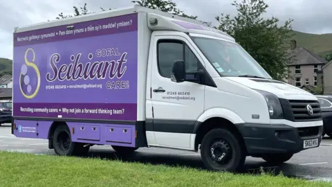 Advert to encourage becoming a carer on a van