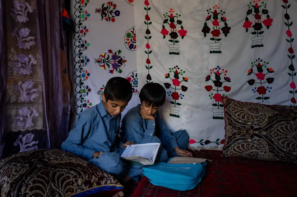 BBC Imran and Bilal doing their homework together. They look out for one another, Abdul Azzi said. Image: Julian Busch/BBC