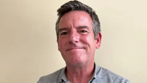 BBC Justin Bell smiles at the camera