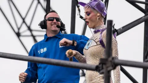 Rex Shutterstock Katy Perry dances with a security guard