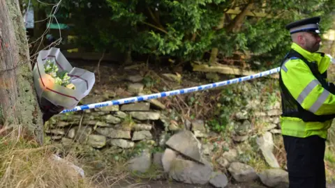 Wales news service A police officer at the scene