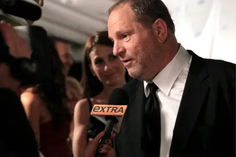 Getty Images Harvey Weinstein talks to a journalist