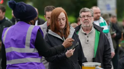 PA Media checking vaccine passport outside Celtic Park