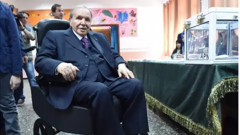 AFP Algerian President Abdelaziz Bouteflika is seen on a wheelchair as he casts his vote at a polling station in Algiers during parliamentary elections, 4 May 2017.