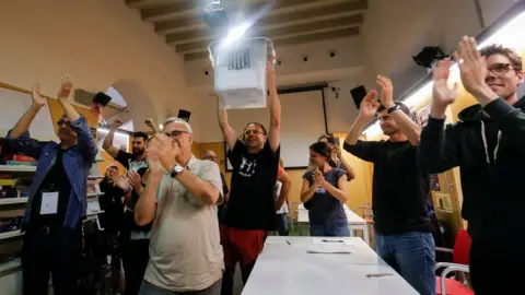 AFP/Getty Images People celebrate after the closing of polling stations outside the "Espai Jove La Fontana" (La Fontana youth centre) on October 1, 2017 in Barcelona