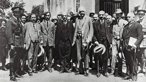 AFP Photo taken in 1925 shows Arthur Balfour (C) and Chaim Weizmann (3rd-R), the then future first President of Israel, visiting Tel Aviv