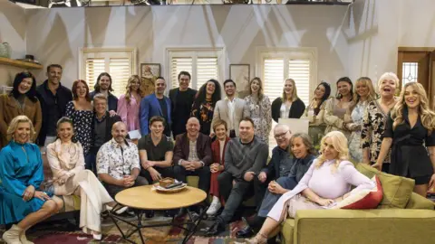 Getty Images The neighbours cast on their last day of filming sat together on a sofa