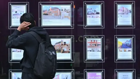 Getty Images Person looks at estate agent's window