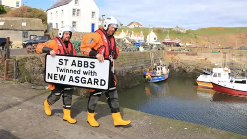 St Abbs Lifeboat Lifeboat crew with sign