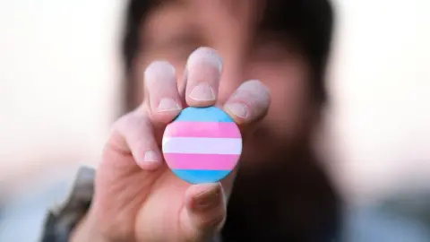 Getty Images A pin badge with transgender colours flag