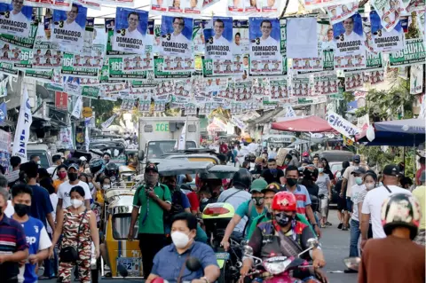 Getty Images Political banners hang over a traffic-clogged street in the Port of Manila on election day, Monday, May 9, 2022.