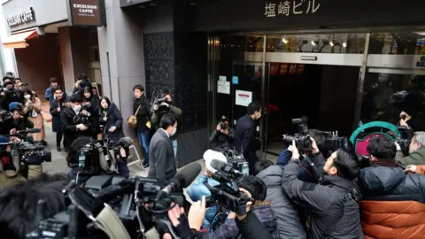 Getty Images Prosecutors entering the offices of the leading LDP this week in relation to the fraud investigation