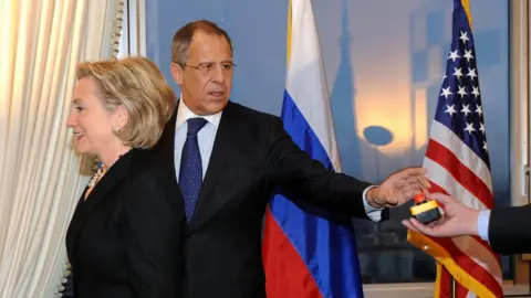 Getty Images US Secretary of State Hillary Clinton (L) smiles with Russian Foreign Minister Sergei Lavrov after she gave him a device with red knob during a meeting on March 6, 2009 in Geneva.