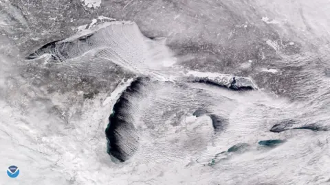 Reuters Satellite image from above the Great Lakes showing parallel rows of cumulus clouds also known as "cloud streets"