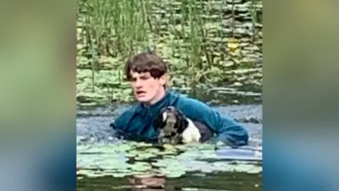 Jane Warner Connor bringing Charlie out of the water