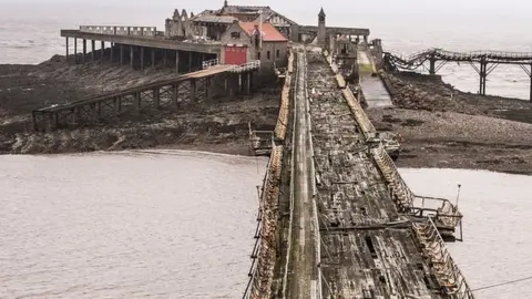 PA Media Birnbeck Pier showing a broken-down walkway in the foreground