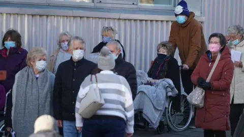 Owen Humphreys/PA Wire People queuing for vaccine in Newcastle