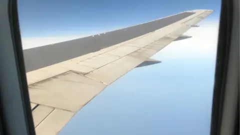 Passenger aircraft wing seen through window