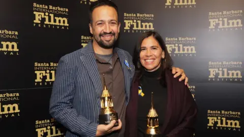 Getty Images Lin-Manuel Miranda and Germaine Franco pose with their Variety Artisans Awards during the 37th Annual Santa Barbara International Film Festival