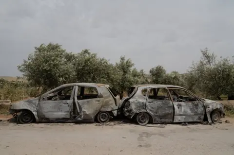 BBC Torched cars in the West Bank village of al-Mughayyir. Settlers burned more than 20 homes and 100 cars during their attacks