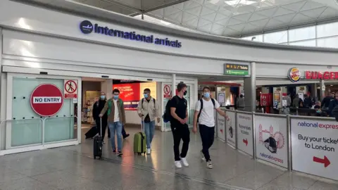 John Fairhall/BBC Arrivals at Stansted
