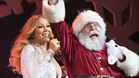 Getty Images Mariah Carey and Santa Claus