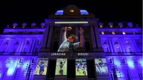 Reuters Image shows a tribute being beamed onto a building in Buenos Aires