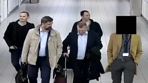 AFP/Getty Images CCTV footage of four suspects travelling to the Netherlands on diplomatic passports earlier this year