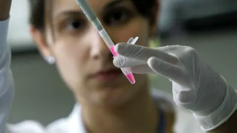 Getty Images Scientific researcher extracting RNA