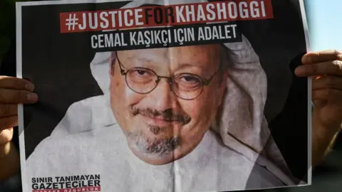 AFP Friends of Jamal Khashoggi hold posters bearing his picture as they attend an event marking the second anniversary of his killing in Istanbul (2 October 2020)