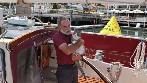 Getty Images Bob Williams with Oli the cat onboard Sylph VI