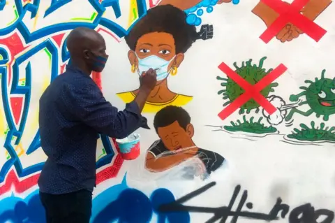 AFP Congolese artist Chris Shongo paints a mural in Kinshasa.