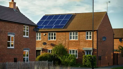 Getty Images House with solar panels on roof in England