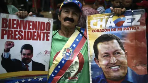 Getty Images Supporters of Venezuela's President Nicolás Maduro take part in a march in Caracas, 13 April 2019