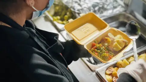 Birmingham New Street Station Volunteer serving food