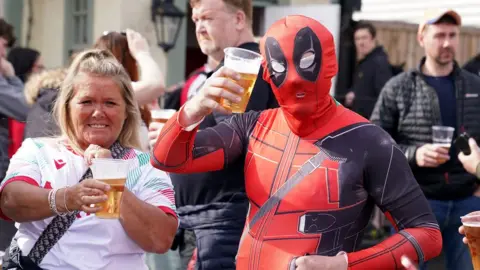 PA Media Fans in fancy dress