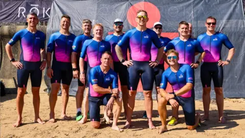 Getty Images Alix Popham with his team members before competing in the Ironman event