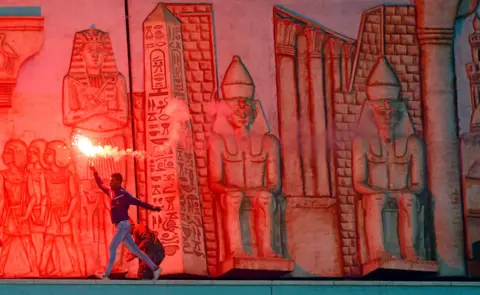 Reuters Egypt's Al Ahly v Gabon"s CF Mounana - Cairo International Stadium, Cairo, Egypt - March 6, 2018 - An Egypt's Al Ahly fan shouts slogans against the Interior Ministry whilst running with a flare during the game.