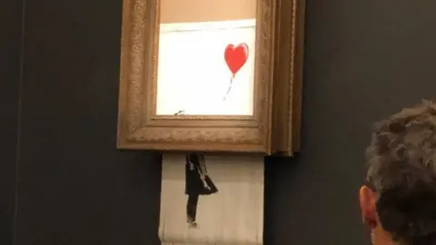 Sotheby's Banksy's Girl With Red Balloon mysteriously shreds after its sale