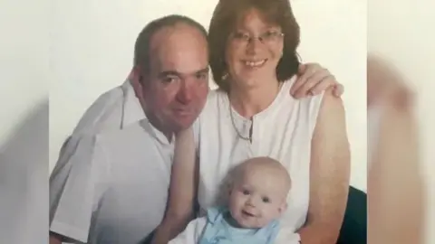 West Mercia Police Yvonne pictured with her late husband and her son.