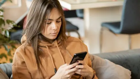 Young woman looking at mobile phone