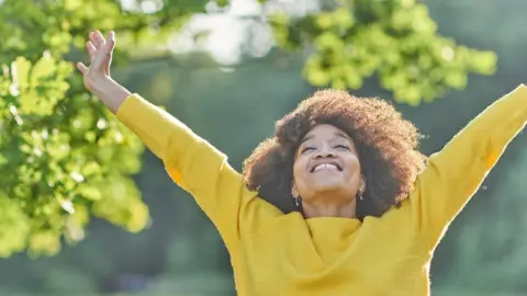 Getty Images Smiling woman in the sunshine