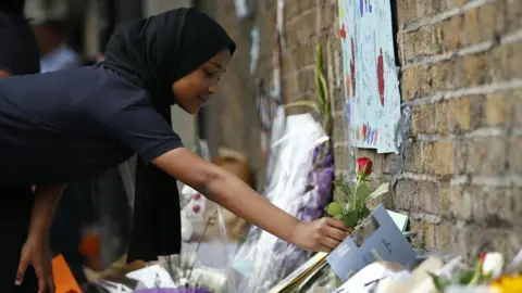 Getty Images Children lay flowers in tribute to the victims of a van attack in the Finsbury Park area of north London.