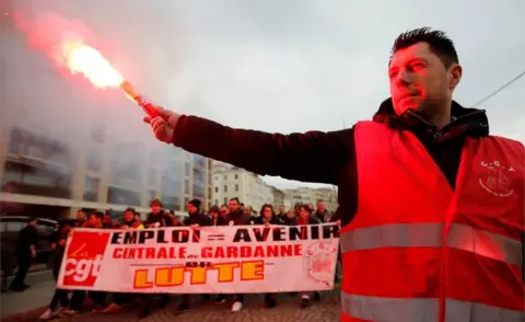 Reuters A protester holds up a flare as French Labour unions members demonstrate against the French government's pensions reform plans in Marseille