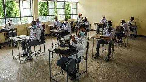 Getty Images Students of Al-Haramain secondary school wait for their class to start as they attend their first day of re-opened school in Dar es Salaam, Tanzania, on June 1, 2020.