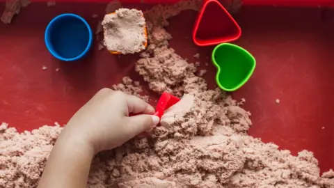 Child playing with sand