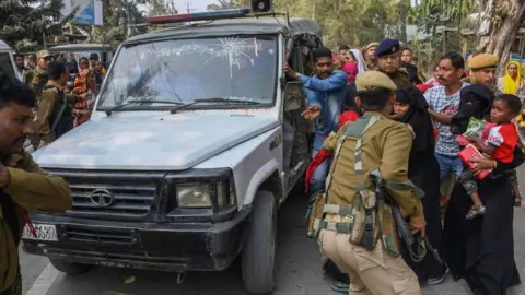 Getty Images Police personnel take arrested people allegedly involved in child marriages to present before a court in a vehicle as their relatives react, near Mayong police station in Morigaon district of Assam on February 4, 2023.