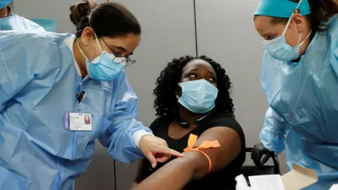 Reuters Nurses take blood from the arm of a woman