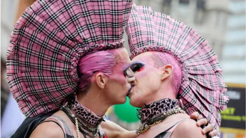 Getty Images Parade goers share a kiss during Pride in London 2019 on July 06, 2019 in London