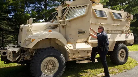 Getty Images A police officer in Maine steps into a mine resistant ambush protected vehicle